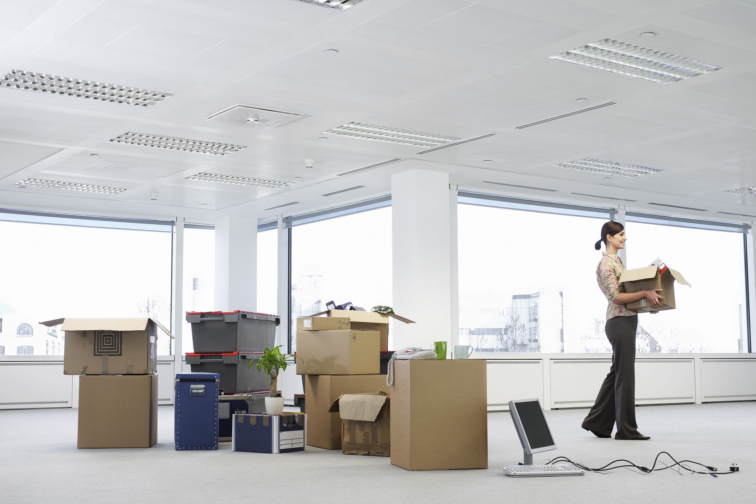 19522699 - businesswoman in office with moving supplies